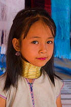 Kayan girl wearing brass coils around her neck to lower the cavicle and make the neck look longer, Thailand 2009