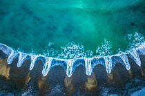 Aerial of patterns of receding waves, Playa del Silencio, Asturias, Spain. April 2018