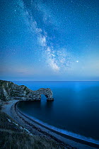 Milky Way above Durdle Door rock arch. Jurasic Coast, Dorset, England, UK. August 2019. Composite image.