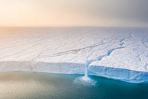Melting ice sheet with  massive  waterfalls running off the Austfonna glacier, the third largest glacier in the world covering most  of Nordaustlandet island, eastern Svalbard, Norway. ~Winner of True...