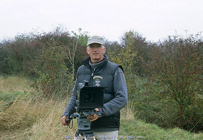 Stock photo of Camerman Paul Johnson filming on location, UK, 2003 (d ...