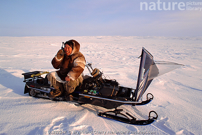 Gps Inuit Stock photo of Inuit hunter using Iridium satellite telephone on the ...