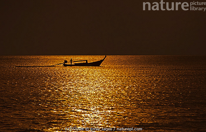 Stock photo of Traditional fishing boat out at sunset, Andaman Sea  Thailand. Available for sale on