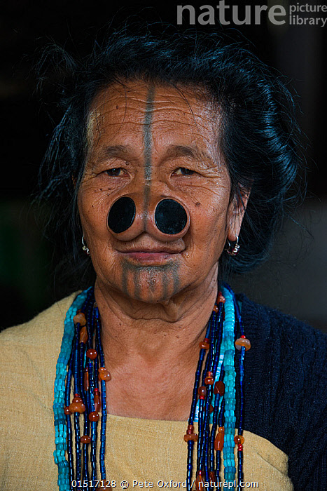 Stock photo of Apatani woman with facial tattoos and traditional cane ...