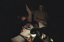 Orca researchers John Ford and Deborah Kavanagh reviewing data in tent, Vancouver Island, British Columbia, Canada