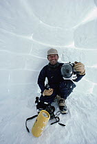Photographer portrait of Flip Nicklin with camera inside igloo