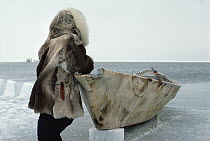 Bowhead Whale (Balaena mysticetus) hunter, an Inuit in traditional clothes with sealskin boat waiting for whales, Barrow, Alaska