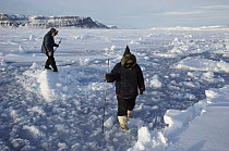 Inuits testing ice strength, Arctic Bay, Baffin Island, Canada