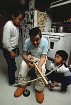 Philipoosie Novalinge shows kids how to use crossbow, he was a role model for the documentary Nanook of the North, Ellesmere Island, Nunavut, Canada
