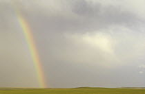 Rainbow over prairie with storm clouds, South Dakota