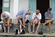 Herpetologists donning pantyhose as a deterrent to Leeches, Tam Dao National Park, Vietnam