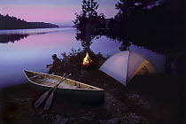 Campers watching sunset, Quetico Provencial Park, Canada