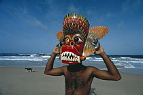 Local man with mask on beach, Sri Lanka