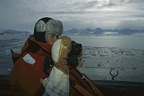 Bearded Seal (Erignathus barbatus) researcher Kit Novaks watching for individuals, Svalbard, Norway