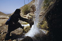 Herpetologist Soheila Shafii cools off under a waterfall, Seyed Ali, Iran