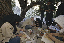Researcher Jim Patton and assistants process rodent specimens for museum as military guard watches, Aaabshar-rayen, Iran