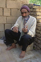 Man smoking a pipe, Deh Bala, Iran