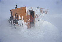 Research scientist Dr. Dale Stokes readies a dive hut after a blizzard, U.S. base at McMurdo Station, Antarctica