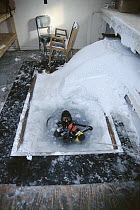Research scientist Dr. Leighton Taylor in a dive hole, U.S. base at McMurdo Station, Antarctica