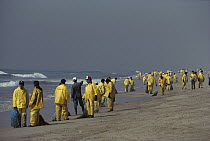 Oil spill on Huntington Beach, workers cleaning up, California