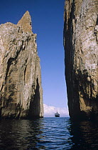Kicker Rock, an old eroded tufa formation with tour vessel, near San Cristobal Island, Galapagos Islands, Ecuador