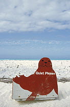 Hawaiian Monk Seal (Monachus schauinslandi) shaped sign reads 'Quiet please, Monk Seal breeding grounds', Midway Atoll, Hawaii