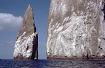 Sailboat dwarfed by Kicker Rock, an old eroded tuff cone, San Cristobal Island, Galapagos Islands, Ecuador