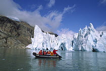 Glacier with tourist expedition in inflatable zodiac, southern Greenland Fjords, Greenland