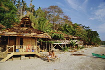 Beachfront tourist bungalows along the shore of Bunaken Island near, Manado, North Sulawesi, Indonesia