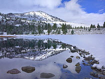 June Lake reflecting snow-covered mountains after clearing storm, eastern Sierra Nevada mountains, California