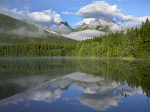 Fortress Mountain shrouded in clouds, reflected in lake, Kananaskis Country, Alberta, Canada