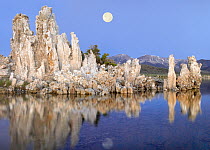 Full moon over Mono Lake with wind and rain eroded tufa towers and the eastern Sierra Nevada Mountains in the background, California
