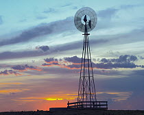 Windmill producing electricity at sunset example of renewable energy, North America