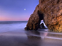 Sea arch and full moon over El Matador State Beach, Malibu, California