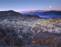 Full moon setting over Zabriskie Point, morning, Death Valley National Park, California