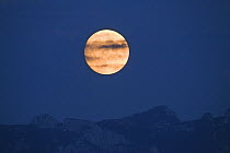 Full moon rising over mountains, Upper Bavaria, Germany