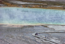 Tourists viewing geyser pool, Lower Geyser Basin, Yellowstone National Park, Wyoming
