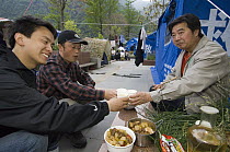Workers sharing a meal in temporary shelters after the May 12, 2008 earthquake and landslides, CCRCGP, Wolong, China