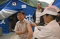 Workers being immunized in temporary shelters after the May 12, 2008 earthquake and landslides, CCRCGP, Wolong, China