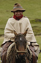 Chagra cowboy on horseback at a hacienda during the annual overnight cattle round-up, Andes Mountains, Ecuador