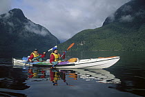 Mother and daughter sea kayaking in Doubtful Sound, Fjordland National Park, South Island, New Zealand