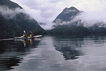Mother and daughter sea kayaking in Doubtful Sound, Fjordland National Park, South Island, New Zealand