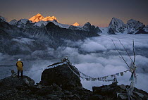 Mountaineer enjoying the view of Mt Everest and the Himalayan Mountains at sunset from Gokyo Ri, Khumbu, Nepal