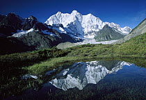 Chomolonzo Peak reflected in small pond, Kangshung Glacier, Tibet