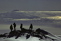 Scientists and field assistants view Mt Discovery from the summit of Mt Erebus, Ross Island, Antarctica