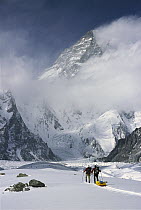 Skiers approaching the base of K2, second highest peak in the world across the Godwin Austen Glacier in the Spring, Karakoram Mountains, Pakistan