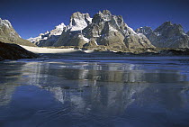 Cathedral Peaks at 5,866 meters elevation at dawn reflected in Baltoro Glacier, Karakoram Mountains, Pakistan