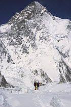 Skiers under K2, second highest peak in the world, Godwin Austen Glacier, Karakoram Mountains, Pakistan