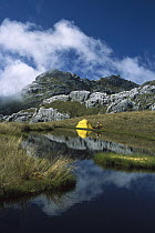 Campsite on tarn amongst limestone formations on Mt Owen, Kahurangi National Park, New Zealand