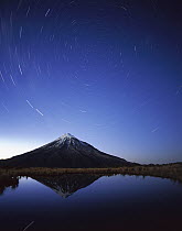 Star trails around the south celestial pole over Mt Taranaki, also known as Mt Egmont (8,261 feet) a dormant volcano in the southwest corner of the North Island near the Tasman Sea, Egmont National Pa...